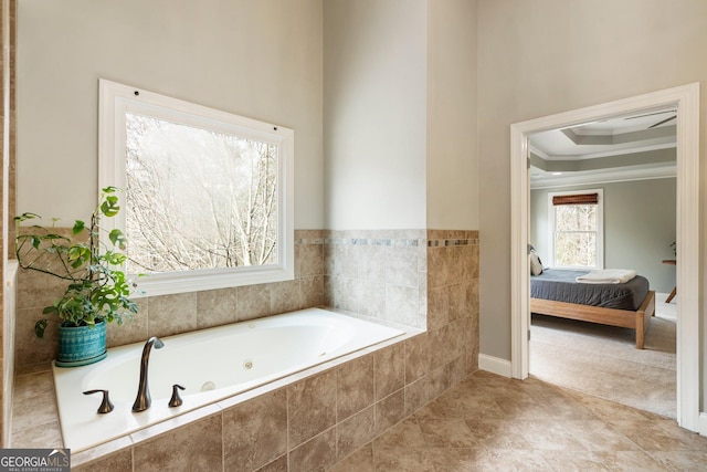 ensuite bathroom with connected bathroom, a raised ceiling, a whirlpool tub, and crown molding