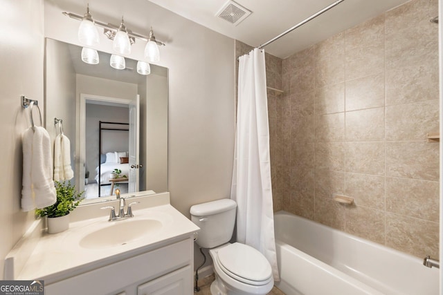 bathroom featuring vanity, toilet, visible vents, and shower / bath combo with shower curtain