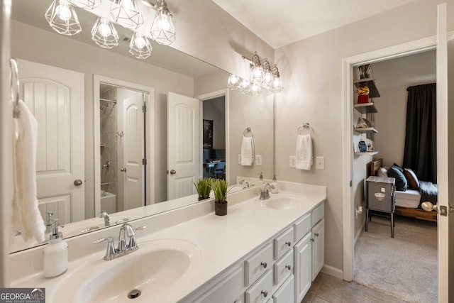 bathroom with double vanity, tile patterned flooring, ensuite bathroom, and a sink