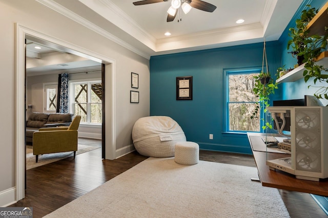 sitting room featuring crown molding, a tray ceiling, and wood finished floors