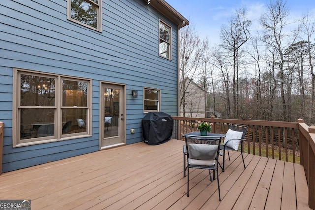 wooden deck featuring a grill