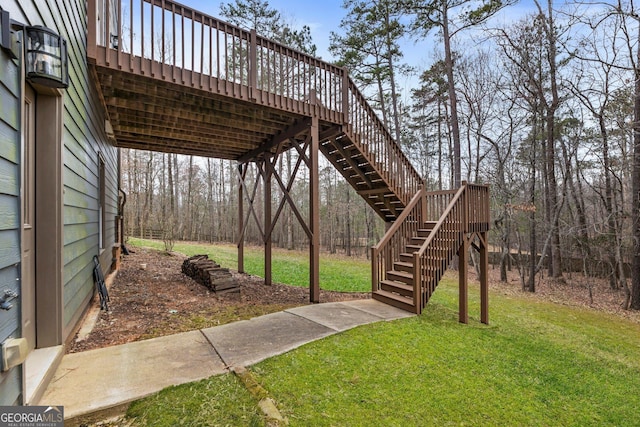 view of yard featuring stairs and a wooden deck