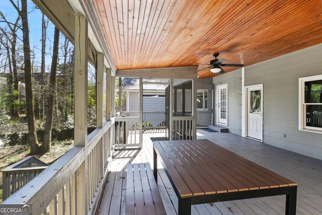 wooden terrace featuring a ceiling fan