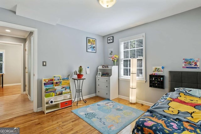 bedroom with baseboards and wood finished floors