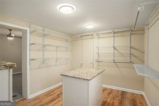 spacious closet with ceiling fan and wood finished floors