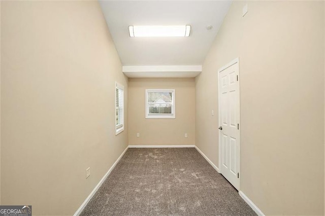 carpeted empty room with baseboards