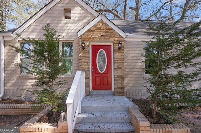 entrance to property with stone siding and brick siding