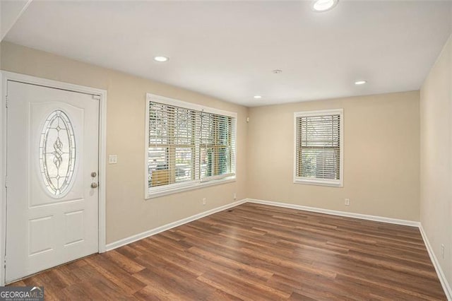 foyer entrance featuring baseboards, wood finished floors, and recessed lighting