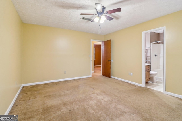 unfurnished bedroom featuring a textured ceiling, carpet flooring, visible vents, and baseboards