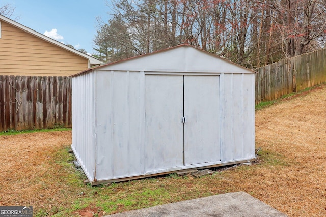 view of shed with a fenced backyard