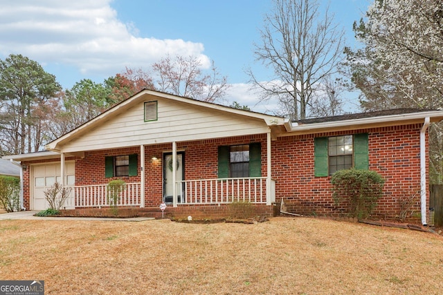 ranch-style home featuring a porch, a front yard, brick siding, and an attached garage