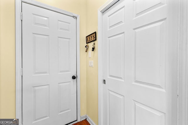 doorway featuring baseboards