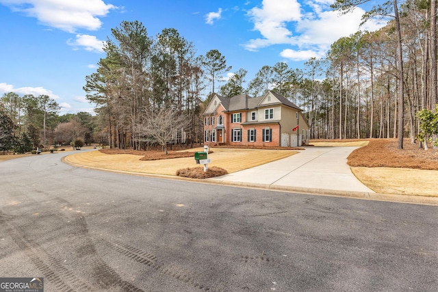 view of front of house featuring driveway and brick siding