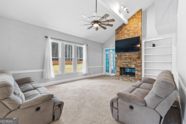 carpeted living area featuring baseboards, ceiling fan, beamed ceiling, a fireplace, and high vaulted ceiling