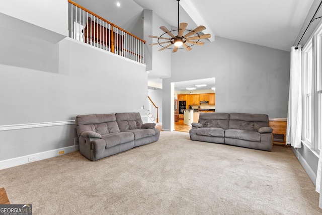 living room with baseboards, a ceiling fan, stairway, carpet floors, and high vaulted ceiling