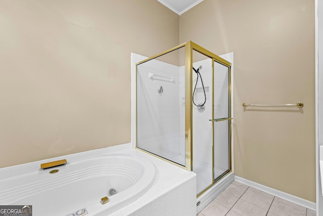 bathroom with baseboards, ornamental molding, a shower stall, a bath, and tile patterned floors