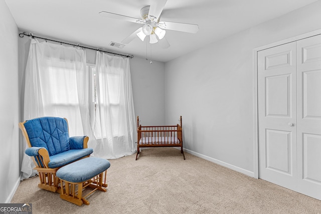 living area with a ceiling fan, carpet flooring, visible vents, and baseboards