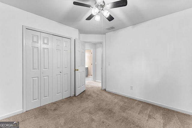 unfurnished bedroom with baseboards, visible vents, ceiling fan, carpet flooring, and a closet