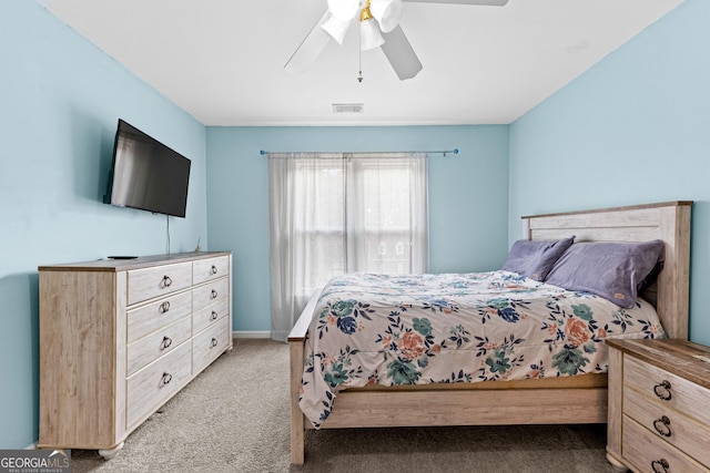 bedroom with a ceiling fan, light colored carpet, visible vents, and baseboards