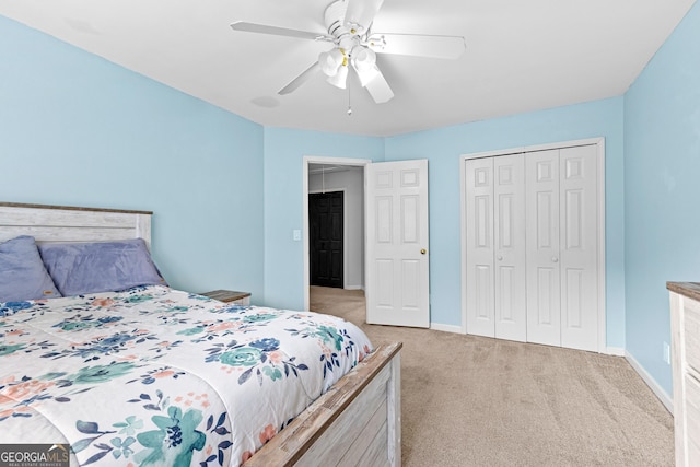 bedroom with light carpet, a closet, a ceiling fan, and baseboards