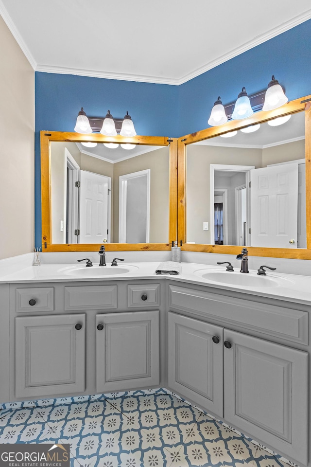 full bathroom with ornamental molding, a sink, and double vanity