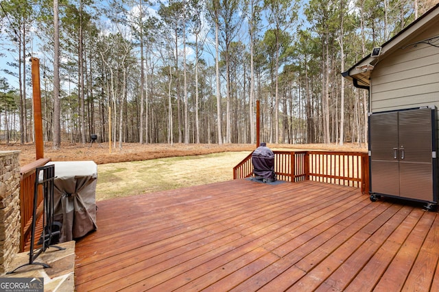 wooden terrace featuring a yard