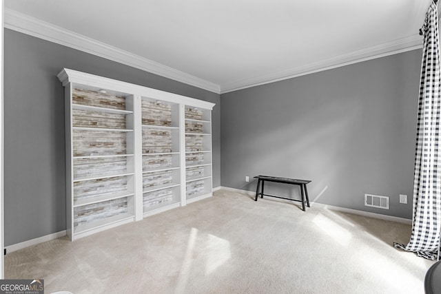 interior space with baseboards, visible vents, and crown molding