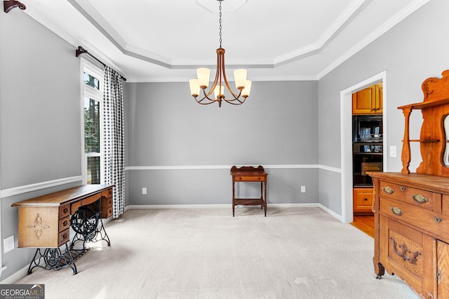 sitting room featuring a chandelier, a tray ceiling, baseboards, and light colored carpet