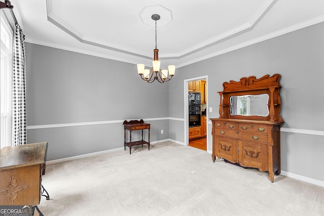 sitting room with light carpet, a tray ceiling, baseboards, and an inviting chandelier