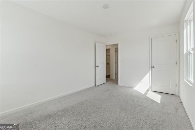 unfurnished bedroom with carpet and baseboards