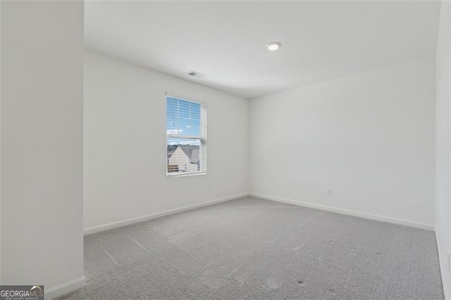 carpeted empty room with baseboards and visible vents