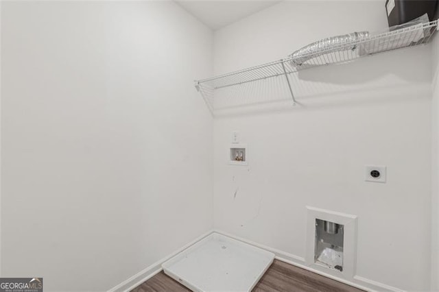 washroom with washer hookup, dark wood-type flooring, electric dryer hookup, laundry area, and baseboards