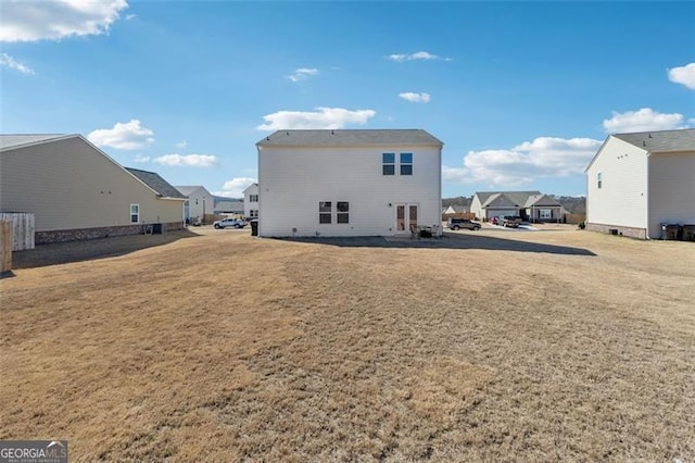 rear view of property with a residential view and a lawn