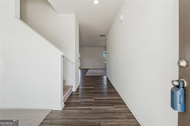 hallway featuring stairs, wood finished floors, visible vents, and baseboards