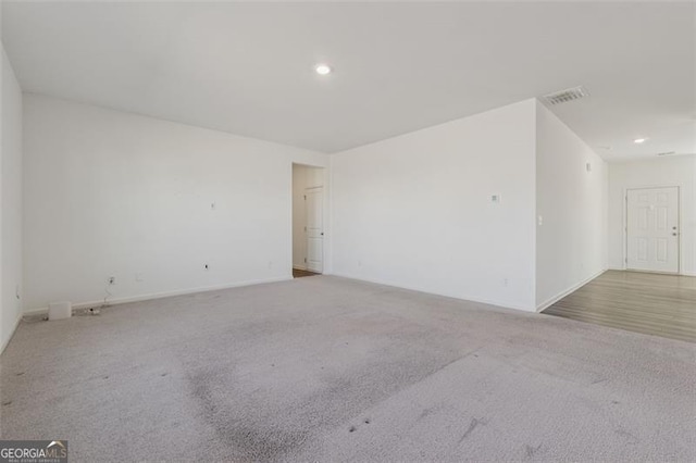 unfurnished room featuring visible vents, carpet flooring, and recessed lighting