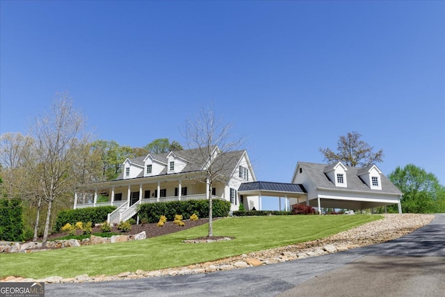 cape cod house featuring a porch and a front yard