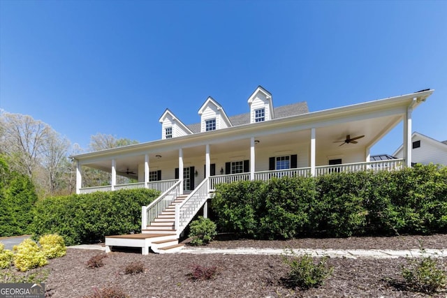 view of front of property with a ceiling fan, covered porch, and stairway