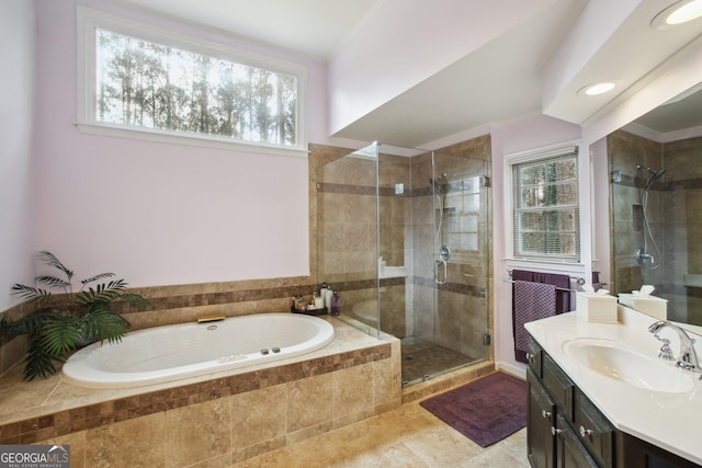 bathroom with a shower stall, crown molding, a bath, and vanity