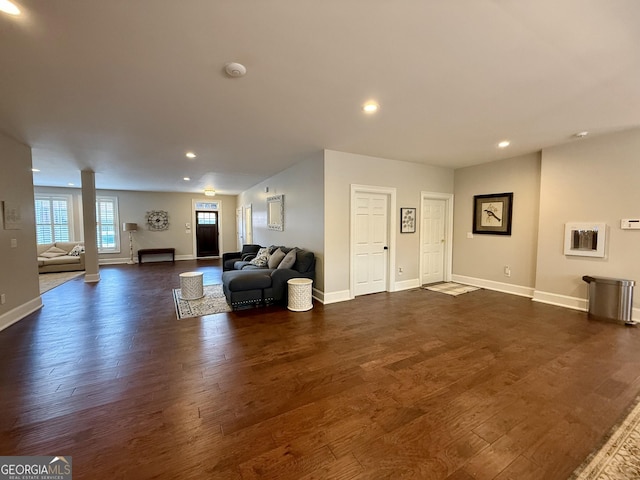 living area featuring recessed lighting, dark wood finished floors, and baseboards