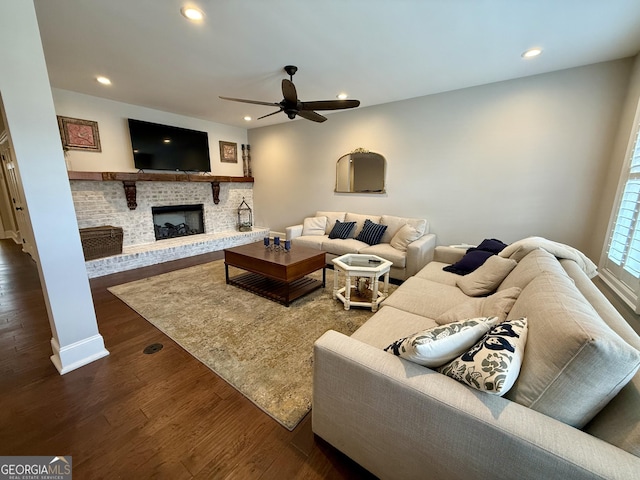 living room featuring ceiling fan, a brick fireplace, dark wood finished floors, and recessed lighting