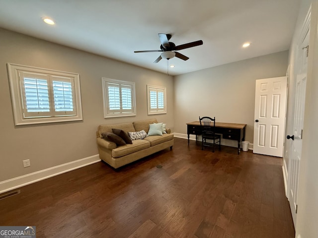 unfurnished living room with baseboards, dark wood-style flooring, and a wealth of natural light