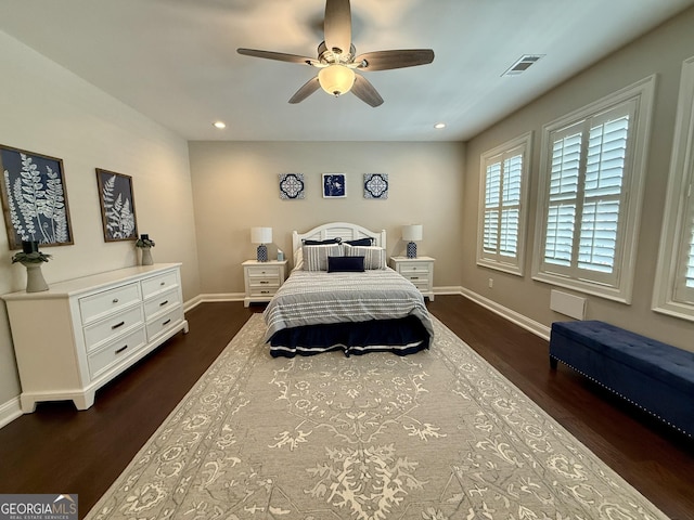 bedroom with baseboards, visible vents, a ceiling fan, dark wood-style floors, and recessed lighting