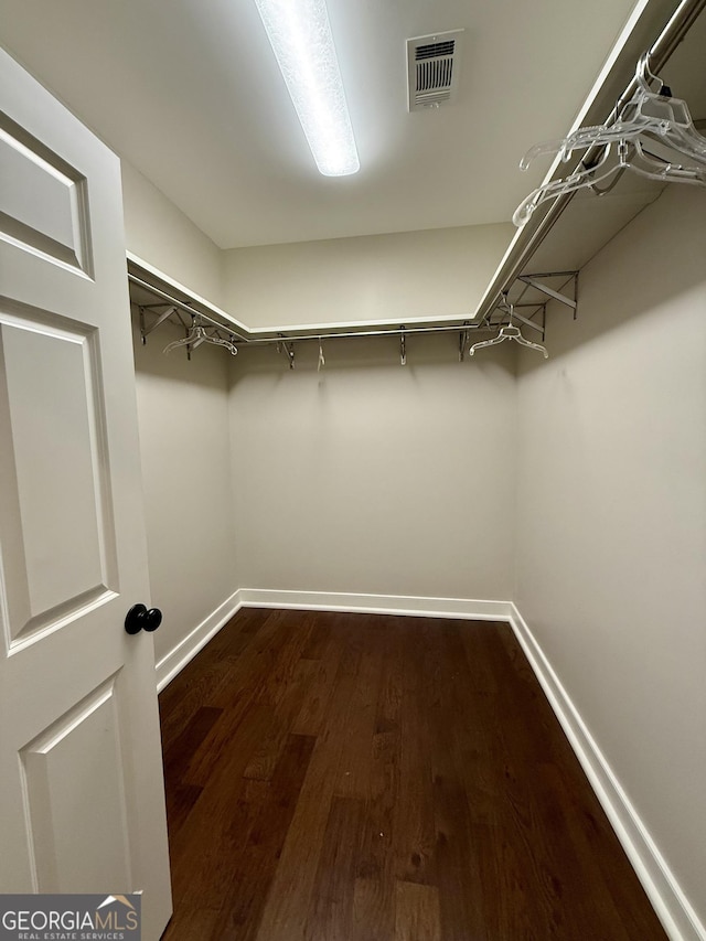 walk in closet featuring dark wood-type flooring and visible vents