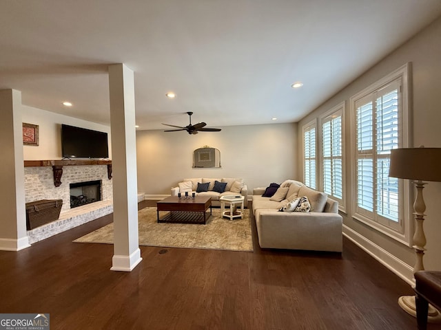 living area with a fireplace, dark wood-type flooring, and recessed lighting