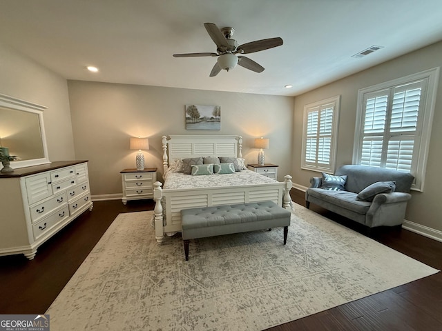 bedroom with dark wood-style flooring, recessed lighting, visible vents, and baseboards