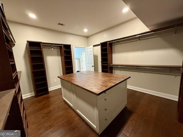 spacious closet featuring dark wood-style flooring and visible vents