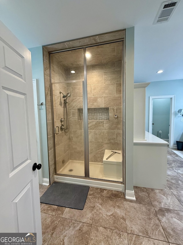 full bathroom featuring visible vents, a shower stall, and baseboards