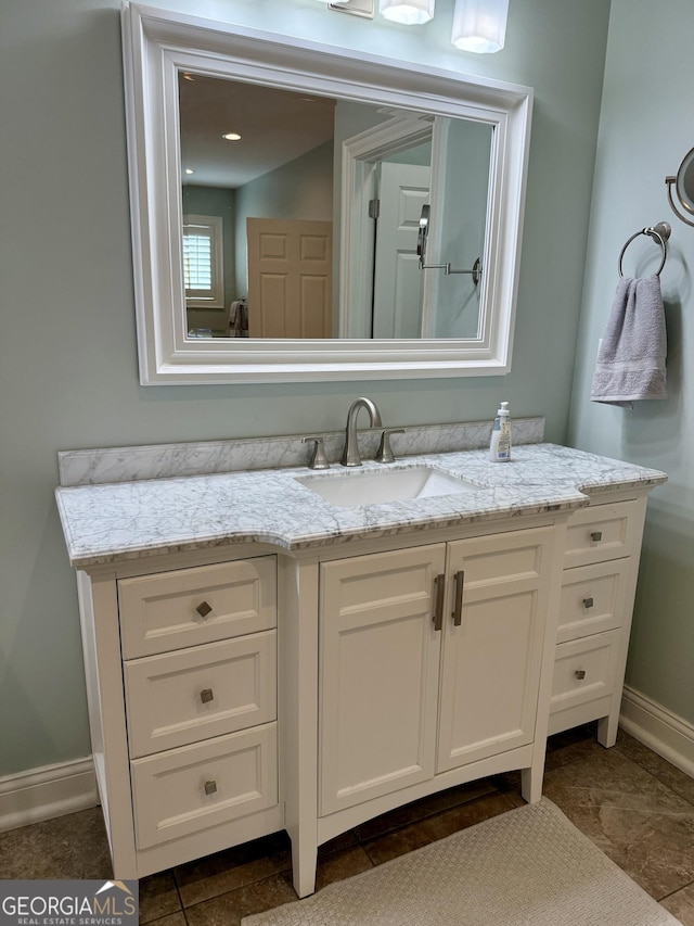 bathroom featuring baseboards and vanity