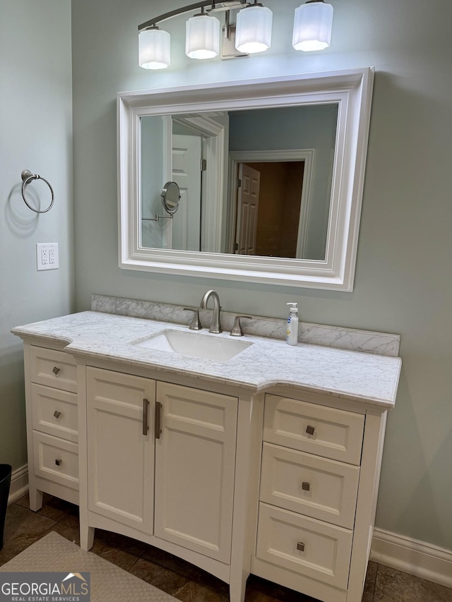 bathroom featuring vanity and baseboards