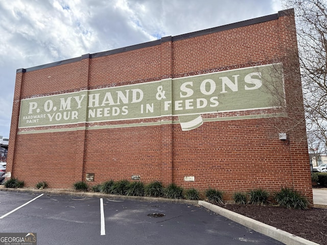 view of building exterior with uncovered parking